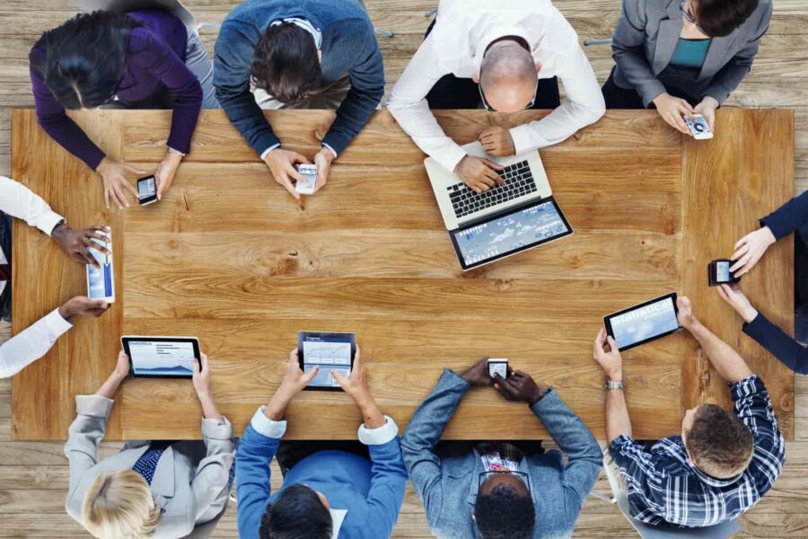 people sitting table devices